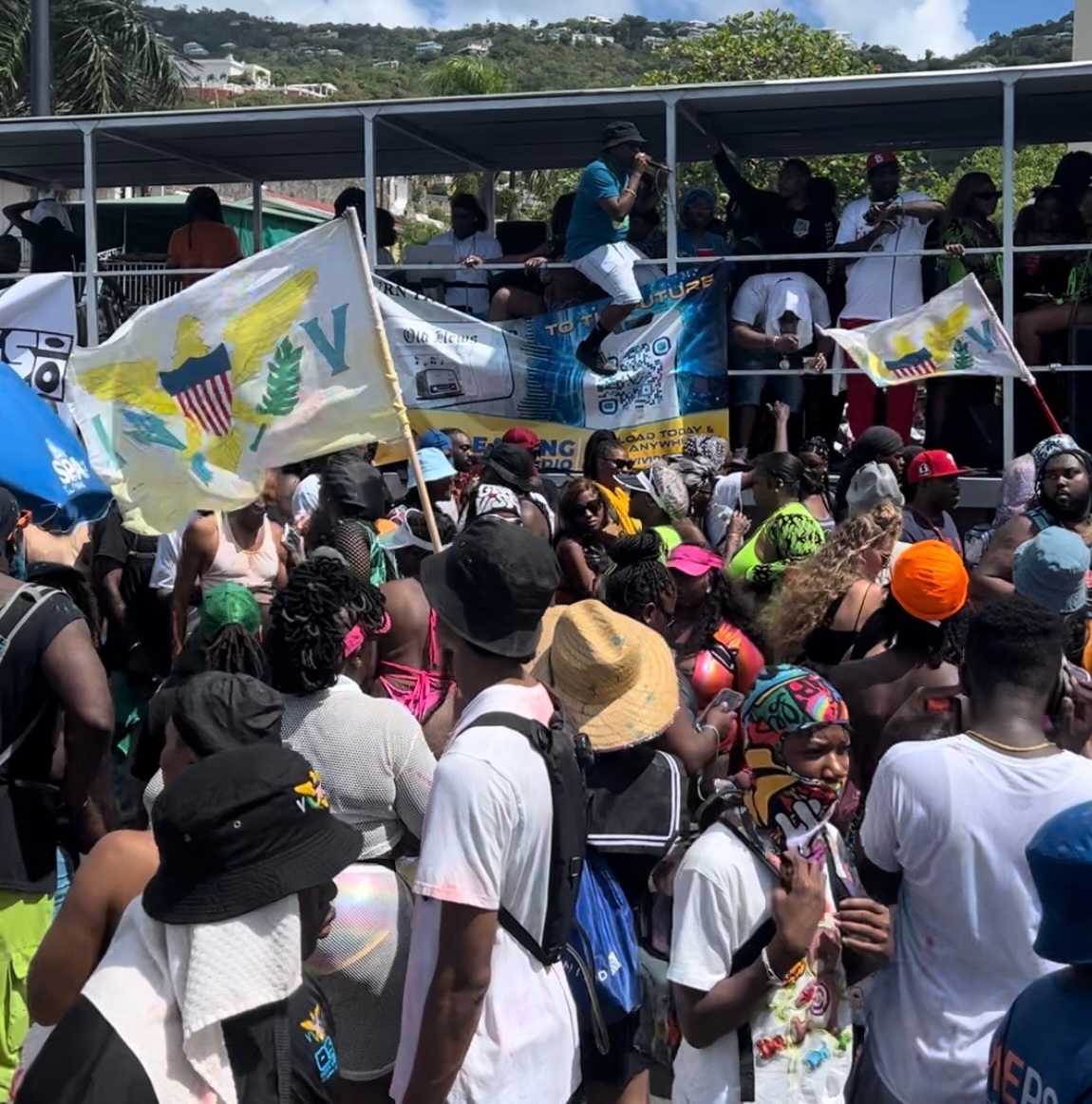 Virgin Islands flags fly as revelers are entertained by one of 11 bands that was on hand to keep the party going. (Source photo by Lara Halliday)
