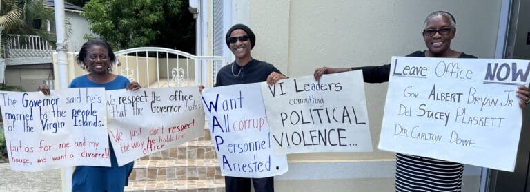 Techla Hanley, Patrick Hanley and Myrtle Barry protest outside the Legislature building on St. John. (Source photo by Amy H. Roberts)