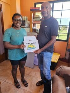 On behalf of the St. Croix Hiking Association, Nick Drayton handed a check of over two thousand dollars in donation to the director of the young Garifuna. (Photo by Olasee Davis)