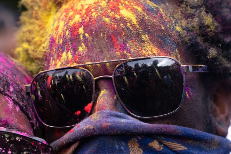 Colored powder covers a reveler's face during the 72nd Crucian Christmas Festival J'ouvert on Thursday morning in Frederiksted. (Source photo by Kit MacAvoy)