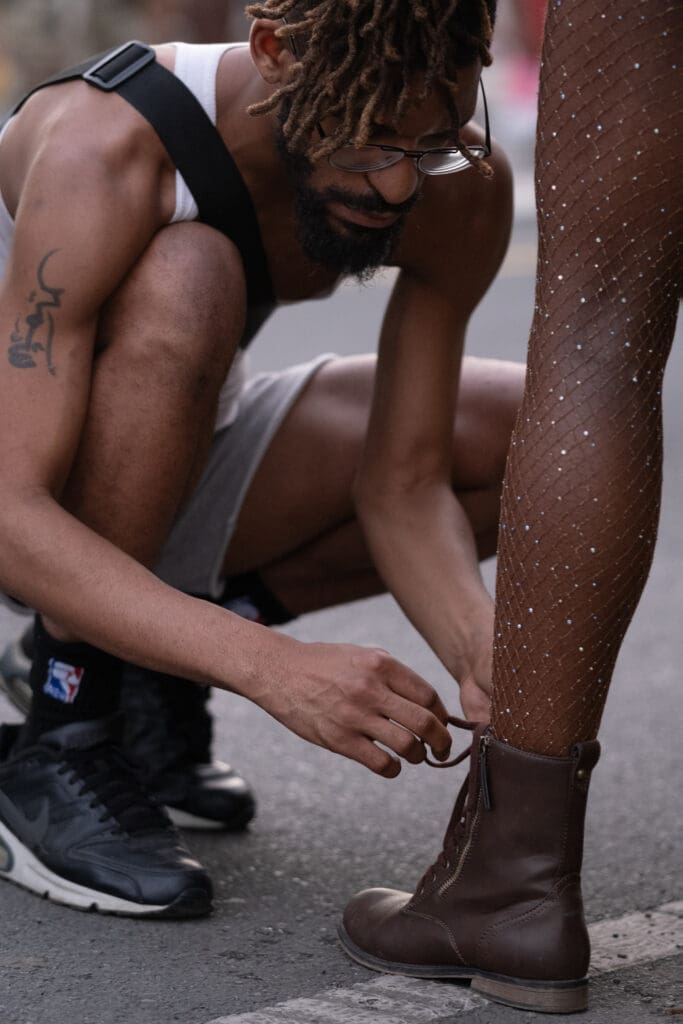 Samir Wadi double-checks the laces of Raevah Matthew before the 72nd Crucian Christmas Festival J'ouvert kicks off at approximately 7 a.m. on Thursday morning in Frederiksted. (Source photo by Kit MacAvoy)