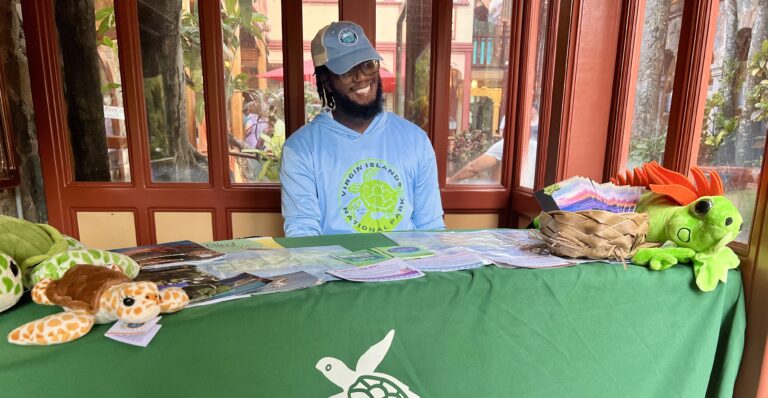 Bookstore attendant Ethan Popo directs visitors to the Friends of the V.I. National Park pop-up store at Mongoose Junction on St. John. (Source photo by Judi Shimel)