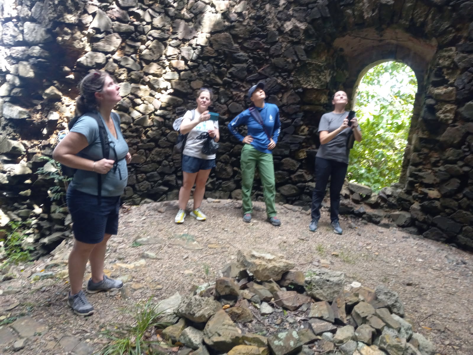 This 1796 sugar mill is at Wills Bay Estate, part of Maroon Country's historic landscape. Tashya Allen from NOAA, in front with her backpack, looks up at the mill opening along with other federal and local government officials. (Photo by Olasee Davis)