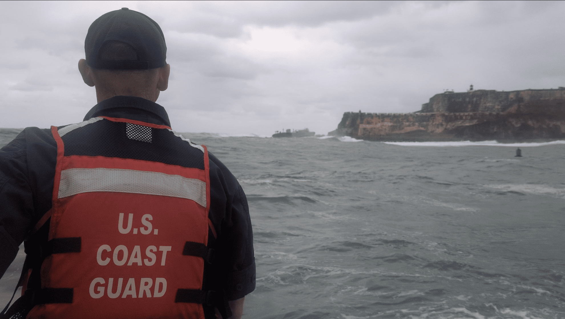 A member of the Coast Guard observes the Defiant, the fuel barge that ran aground Monday off San Juan Harbor in Puerto Rico. (Photo courtesy Coast Guard)