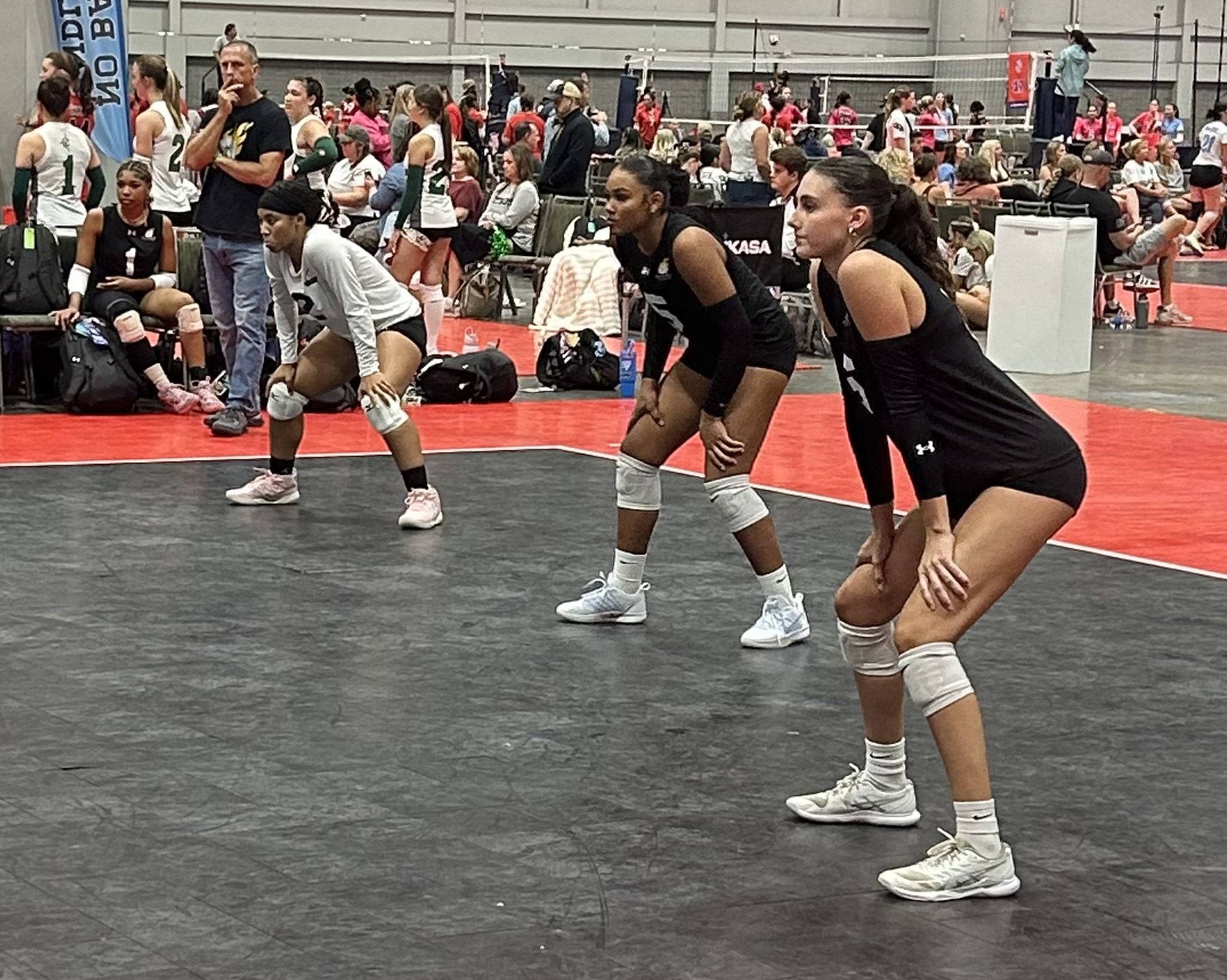 Island Heat 16-1, #2 Aryana Tutein, #5 Anna-Marie Figueroa, and #6 Ava Whitworth prepare to receive the serve in their match against GSA 16 National at the 2026 AAU National Volleyball Championships. (Photo by Mark J. Daniel)